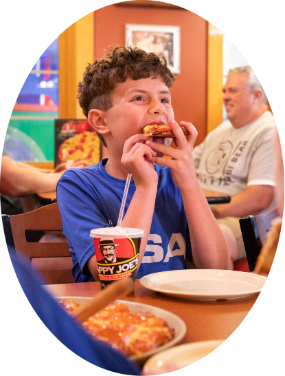 Oval frame with Boy eating a slice of pizza