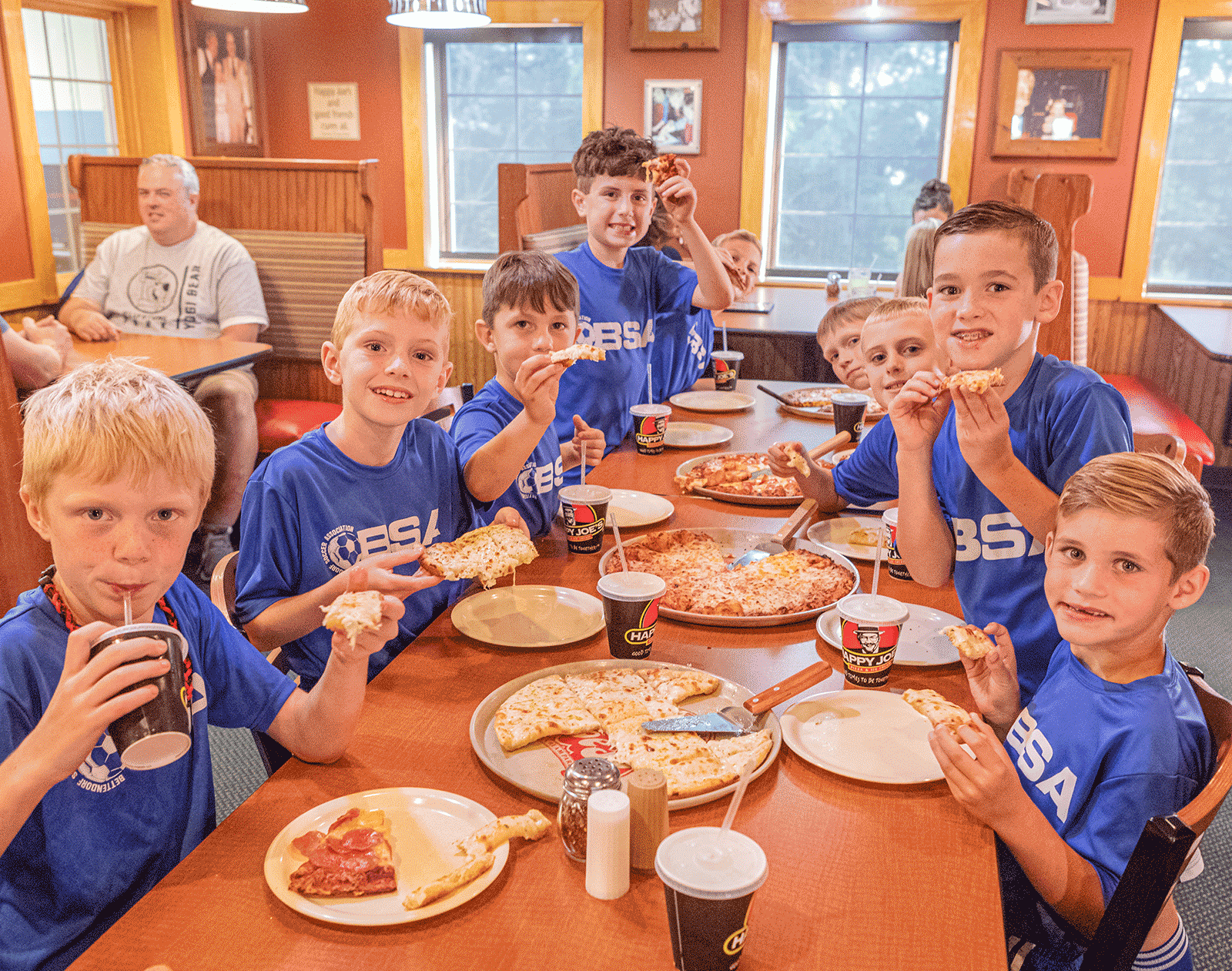 Boys team with Pizza at Happy Joe's Pizza.