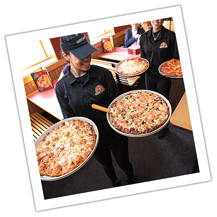 Photograph style image of pizzas being served